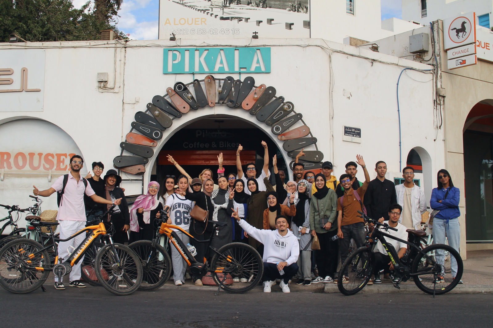 The Sports Innovation Lab community gathered with bicycles outside Pikala